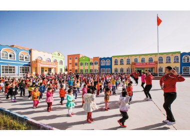 崭新的幼儿园和快乐舞蹈的孩子们